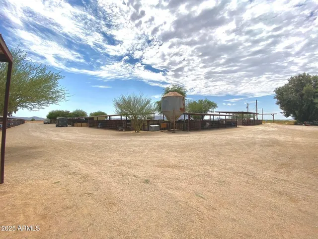 a view of a balcony with wooden floor and outdoor seating