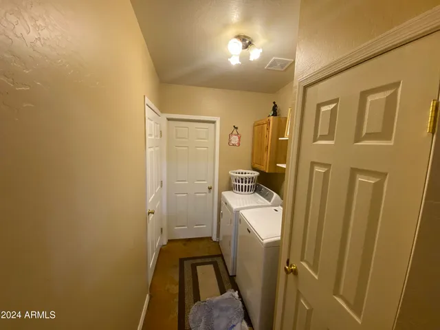 a bathroom with a double vanity sink toilet mirror and shower