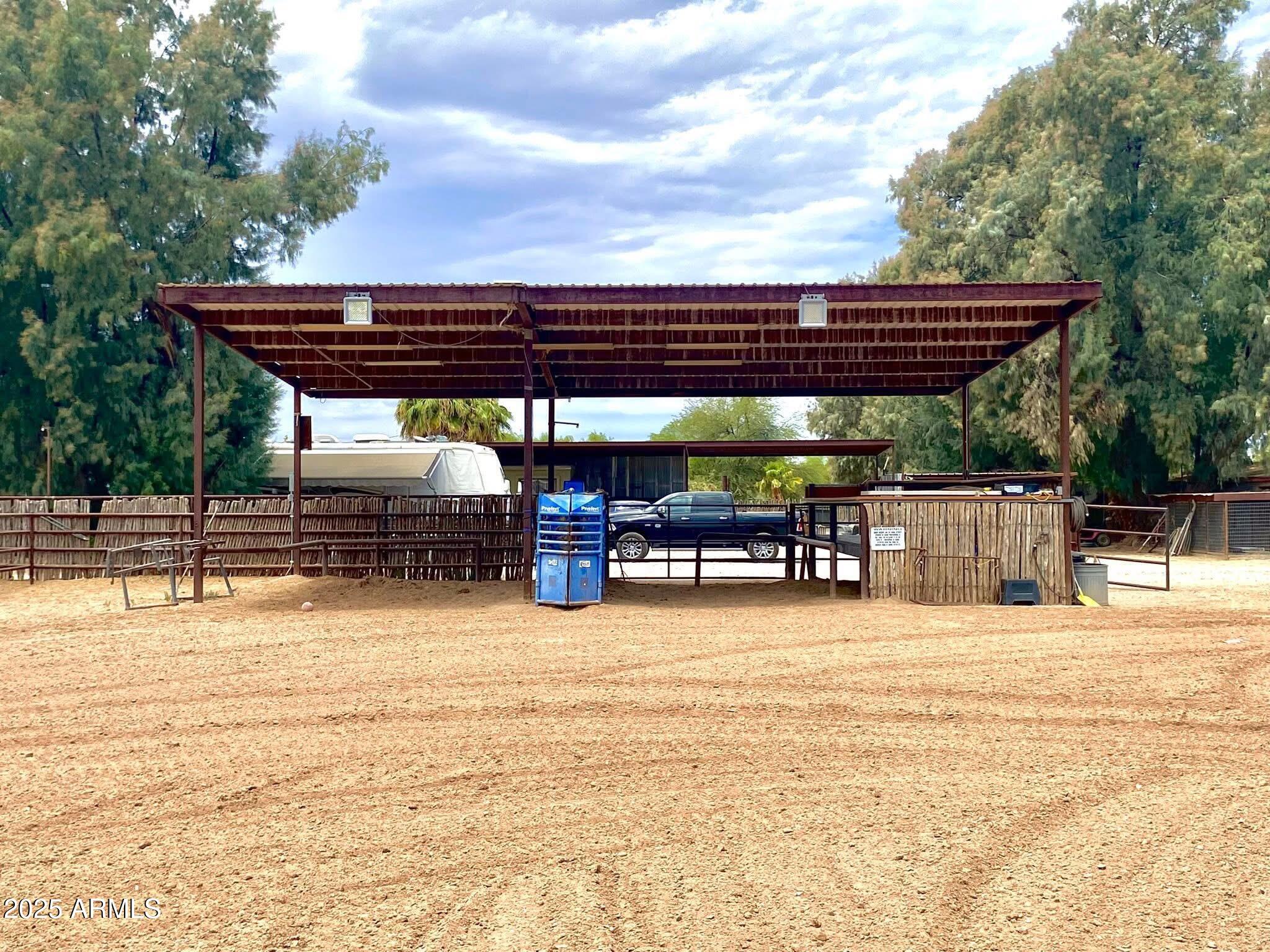 642 East Cornman Road Coolidge, AZ 85128 - Photo 4 of 64 a view of a swimming pool with a lawn chairs under an umbrella