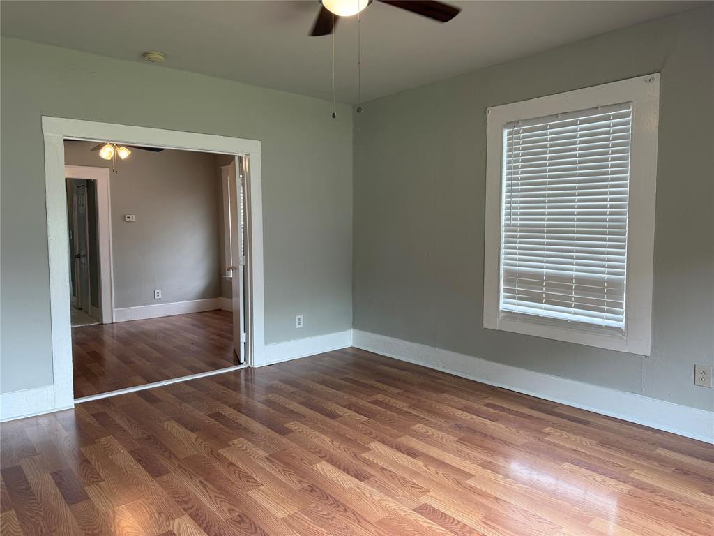 801 Wayne Street Dallas, TX 75223 - Photo 3 of 15 a view of an empty room with wooden floor and a window