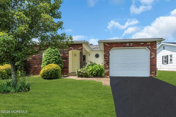 a view of an house with backyard space and garden