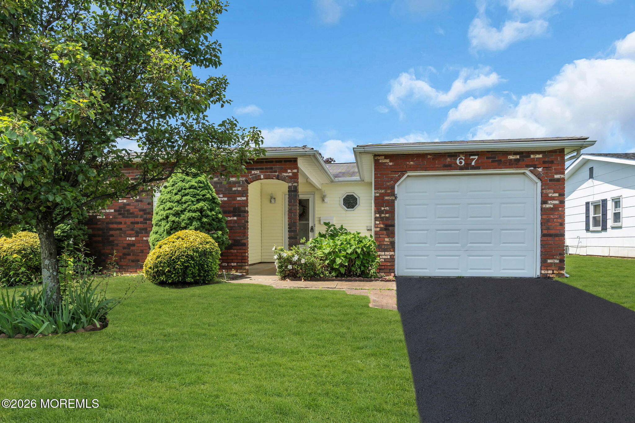a view of an house with backyard space and garden