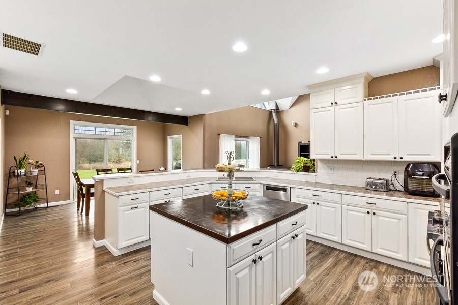 9600 Gastaeson Lane Southwest Rochester, WA 98579 - Photo 15 of 39 a kitchen with a stove a sink and a refrigerator