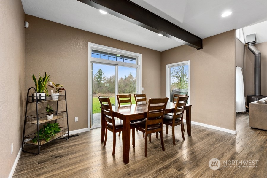 9600 Gastaeson Lane Southwest Rochester, WA 98579 - Photo 17 of 39 a view of a dining room with furniture window and wooden floor