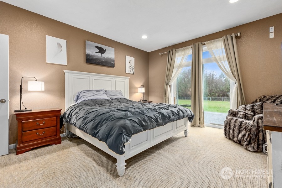 9600 Gastaeson Lane Southwest Rochester, WA 98579 - Photo 20 of 39 a spacious bedroom with a bed and large window