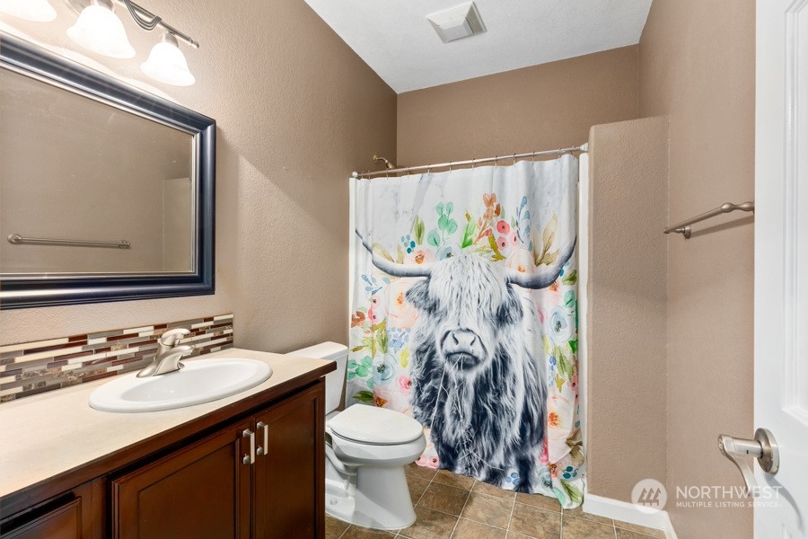 9600 Gastaeson Lane Southwest Rochester, WA 98579 - Photo 23 of 39 a bathroom with a sink vanity mirror and toilet