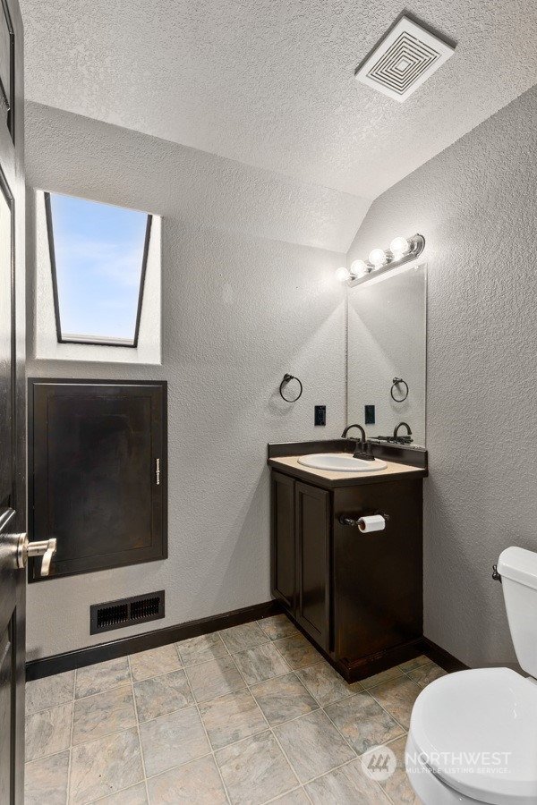 9600 Gastaeson Lane Southwest Rochester, WA 98579 - Photo 30 of 39 a bathroom with a sink vanity and a toilet