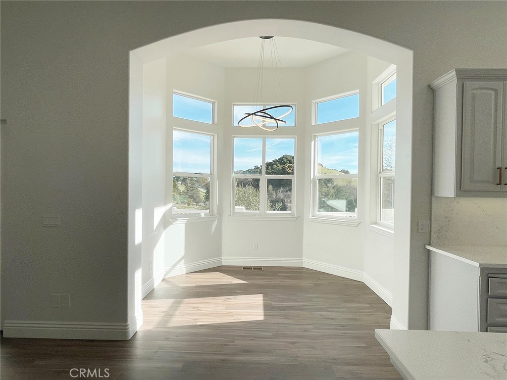 8560 Corriente Road Atascadero, CA 93422 - Photo 12 of 53 an empty room with wooden floor and windows