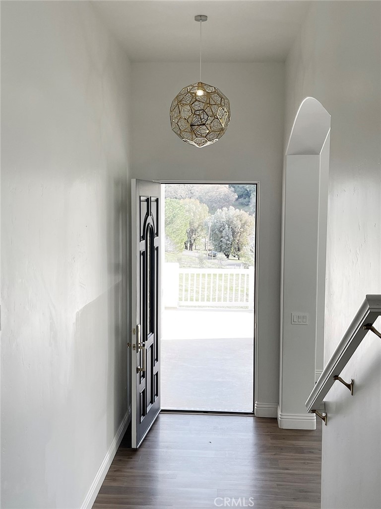 8560 Corriente Road Atascadero, CA 93422 - Photo 20 of 53 an empty room with wooden floor and windows