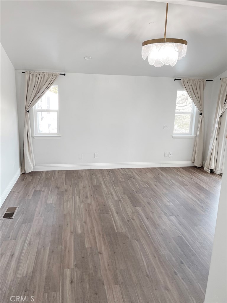 8560 Corriente Road Atascadero, CA 93422 - Photo 21 of 53 an empty room with wooden floor and windows