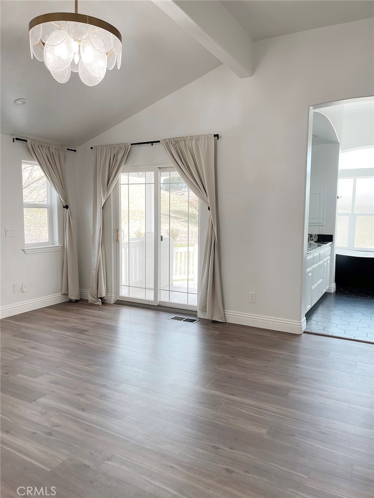 8560 Corriente Road Atascadero, CA 93422 - Photo 22 of 53 an empty room with wooden floor and windows