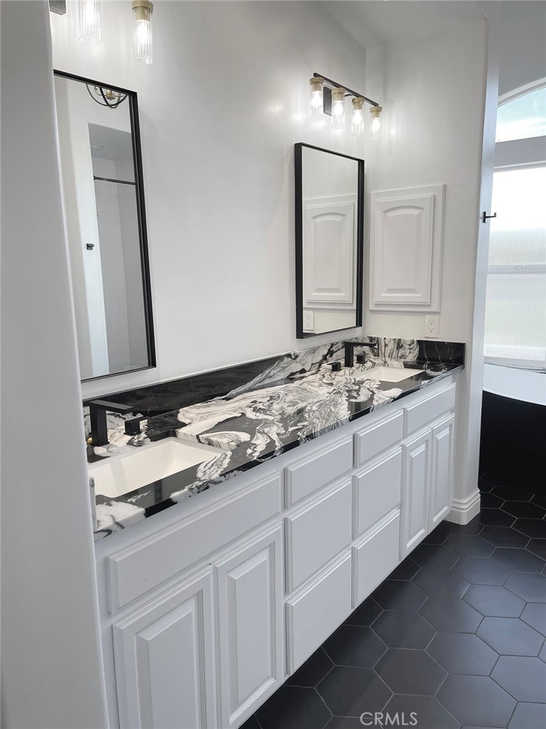 8560 Corriente Road Atascadero, CA 93422 - Photo 25 of 53 a bathroom with a sink and a mirror