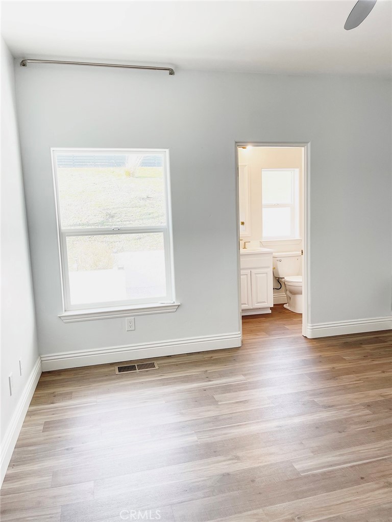 8560 Corriente Road Atascadero, CA 93422 - Photo 29 of 53 a view of an empty room with a window and wooden floor