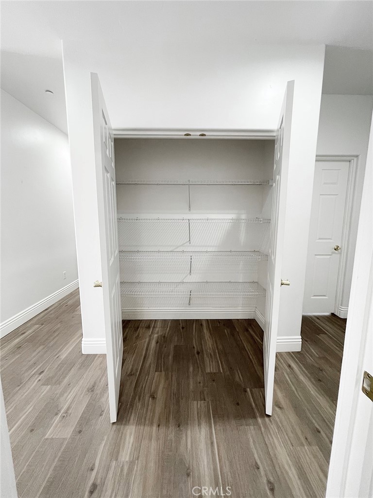 8560 Corriente Road Atascadero, CA 93422 - Photo 45 of 53 a close view of walk in closet with wooden floor