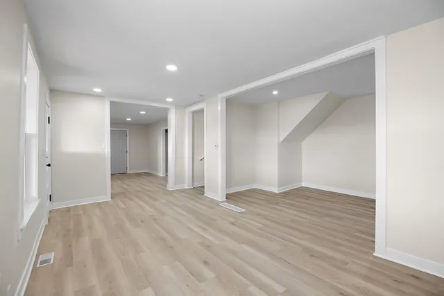 a kitchen with granite countertop a stove top oven microwave and cabinets