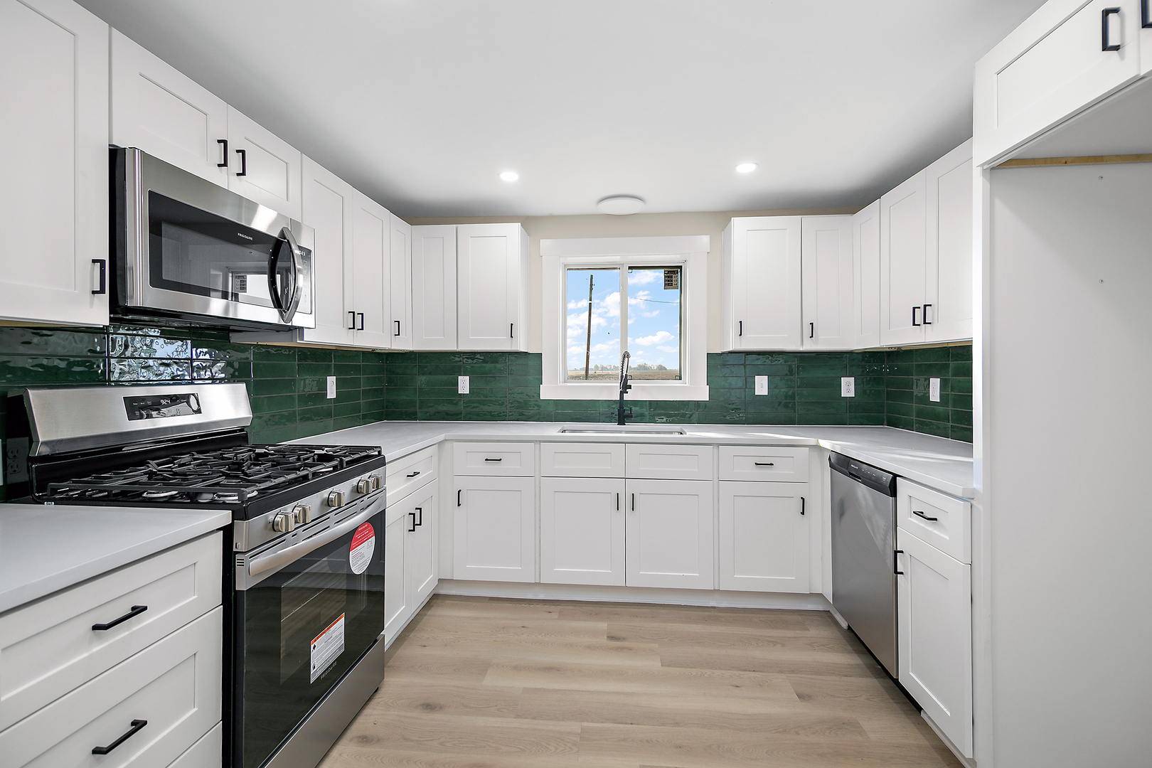 2773 North 900 East Road Ashkum, IL 60911 - Photo 12 of 30 a kitchen with granite countertop a stove top oven microwave and cabinets