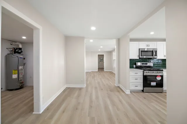 a view of empty room with wooden floor