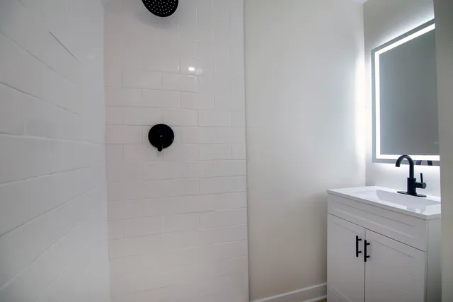 a bathroom with a toilet sink and mirror