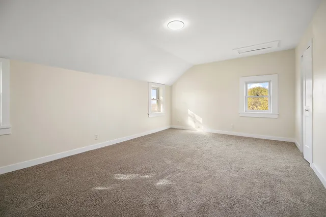 an empty room with windows and closet