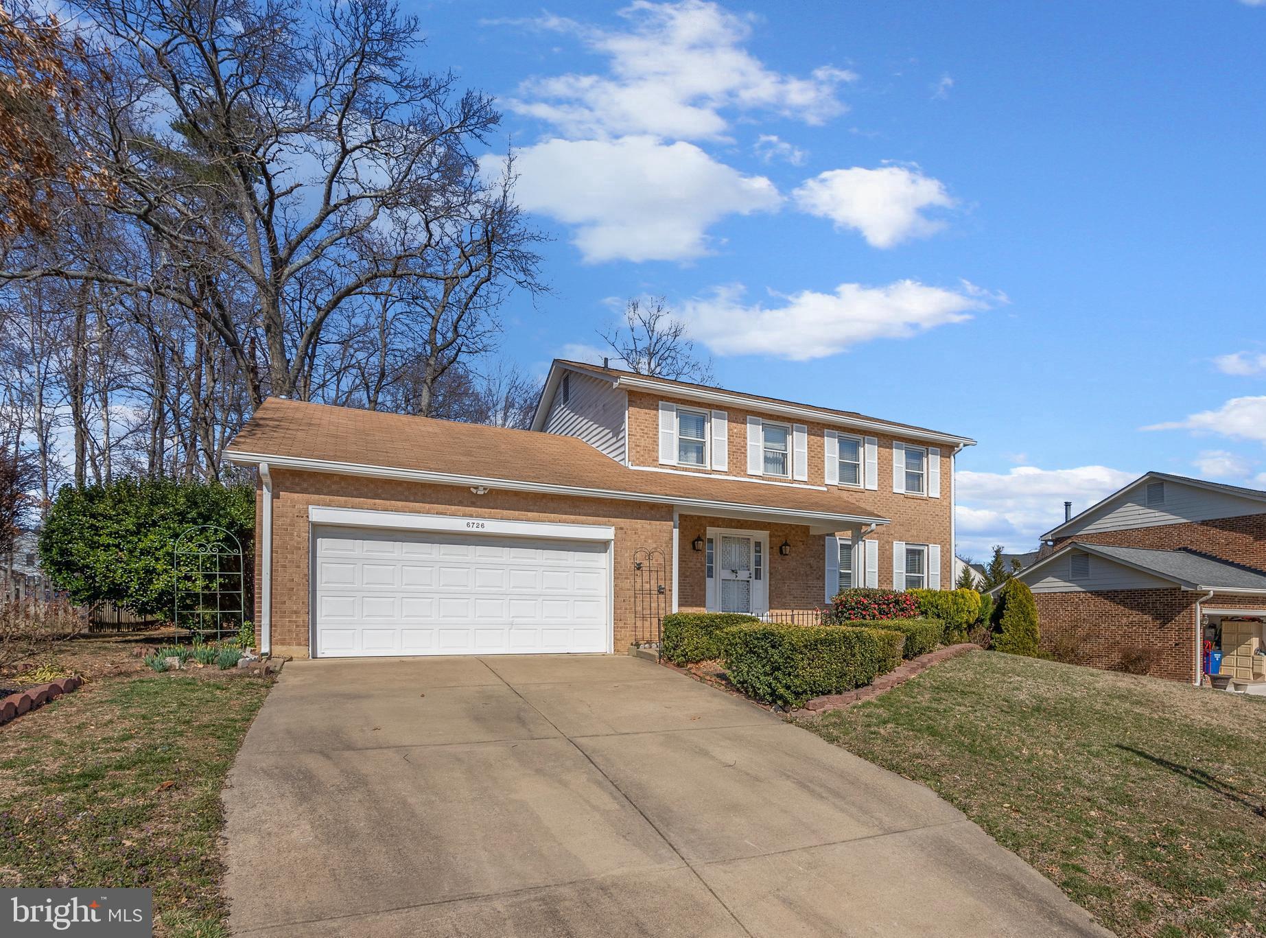 6726 Blanche Drive Lorton, VA 22079 - Photo 2 of 66 a front view of a house with a yard and garage