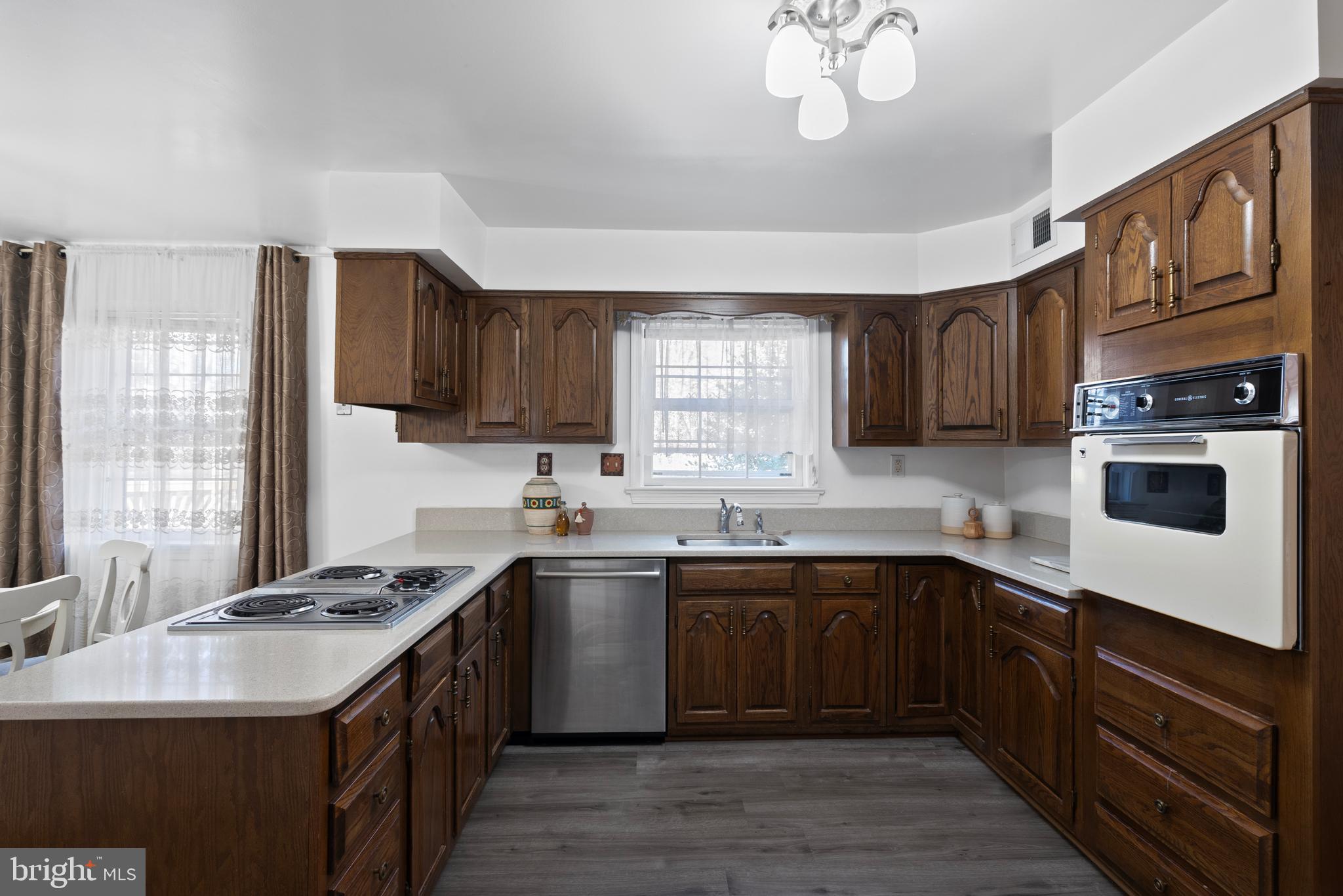 6726 Blanche Drive Lorton, VA 22079 - Photo 26 of 66 a kitchen with stainless steel appliances granite countertop a sink stove cabinets and wooden floor