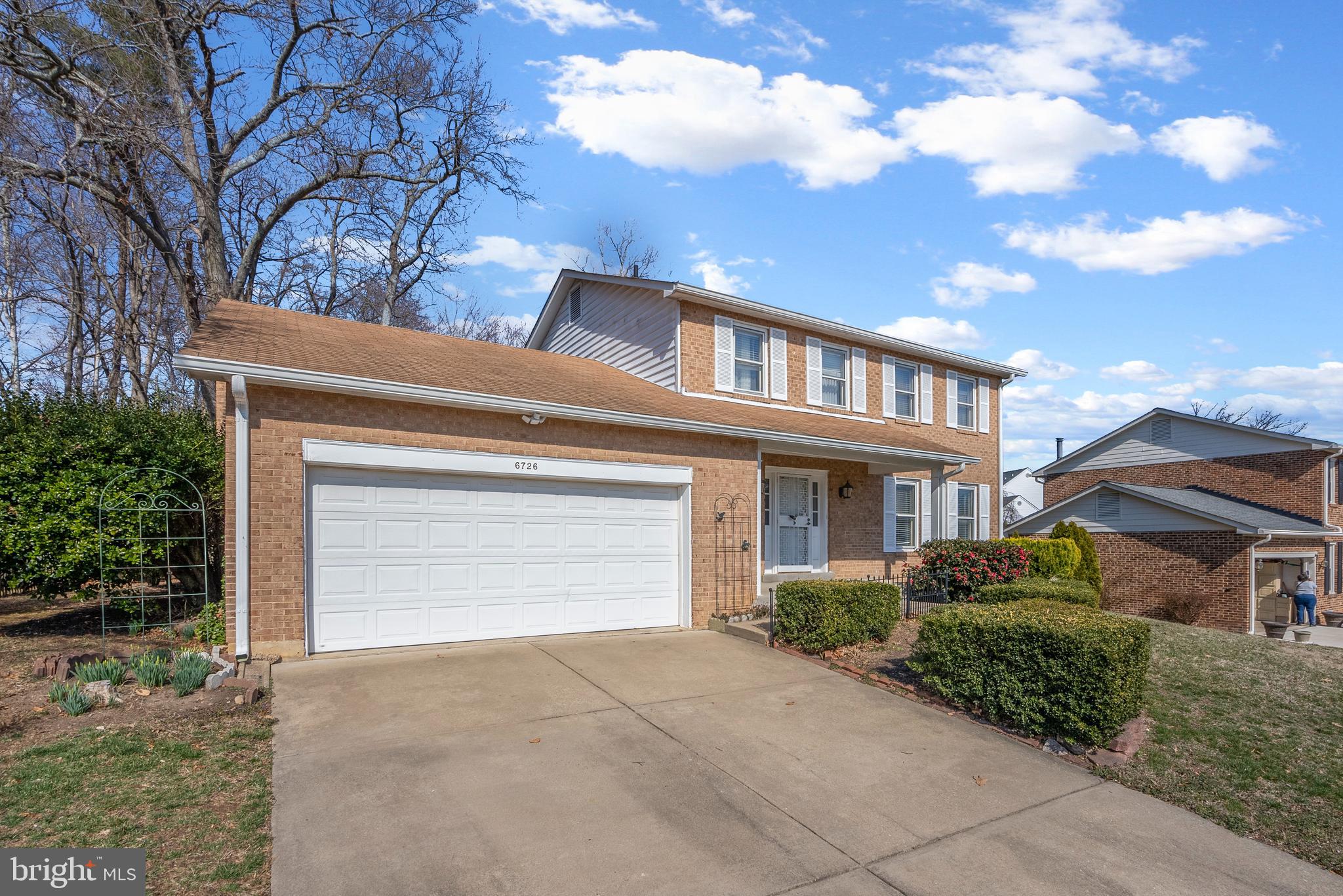 6726 Blanche Drive Lorton, VA 22079 - Photo 5 of 66 a front view of a house with a yard and garage