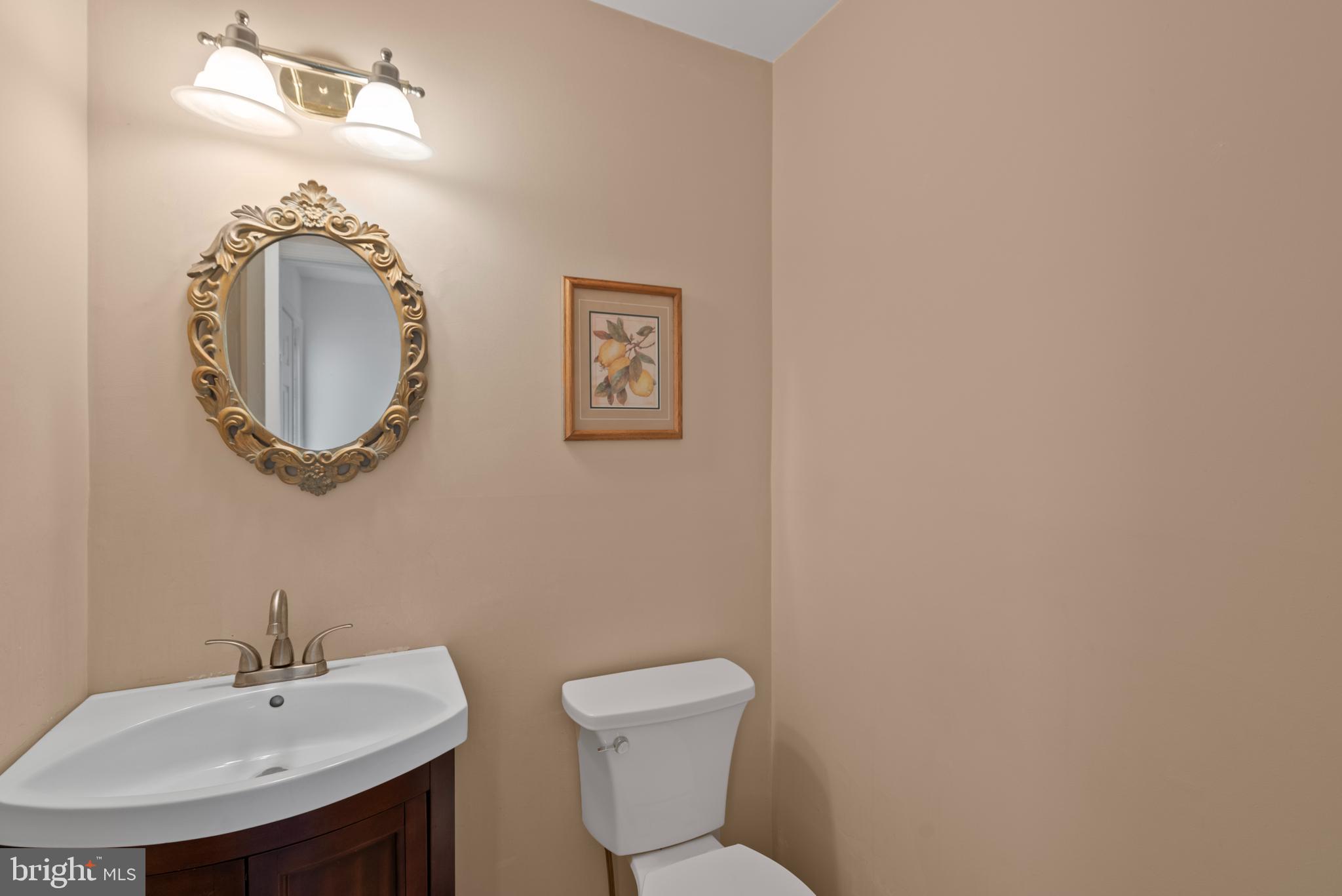 6726 Blanche Drive Lorton, VA 22079 - Photo 8 of 66 a bathroom with a toilet sink and mirror