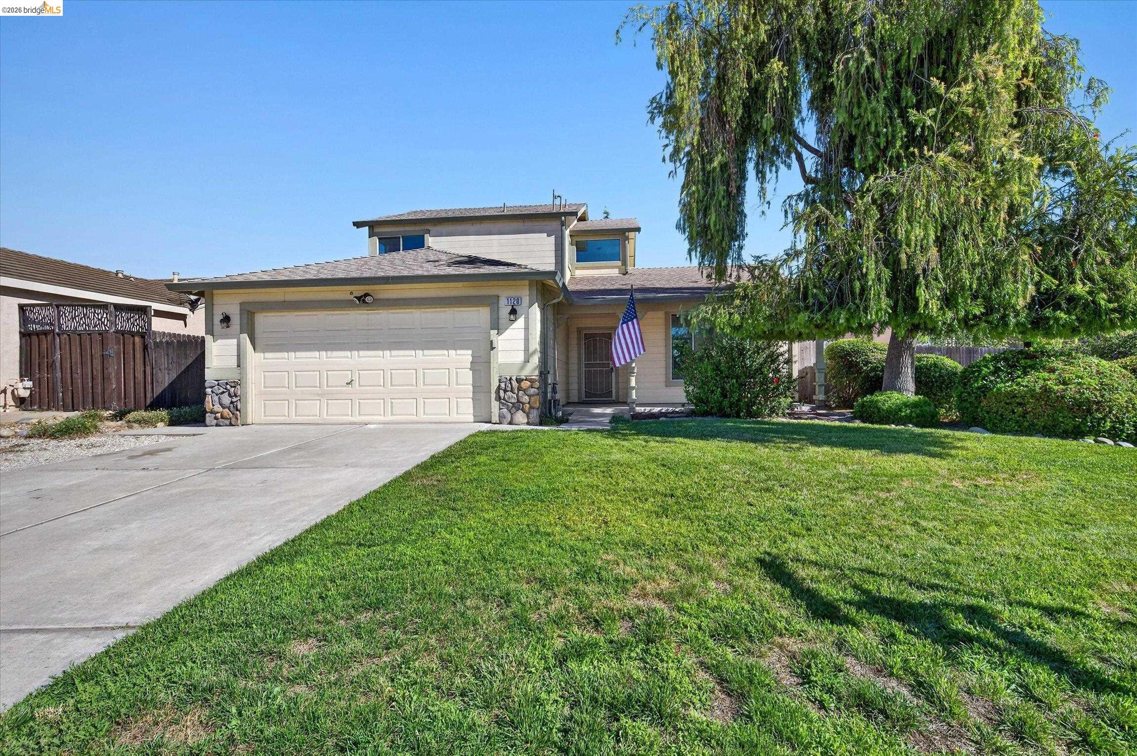 1120 Deerpark Road Oakley, CA 94561 - Photo 1 of 30 Two-story residence featuring a two-car garage, stone veneer accents, and a mature front yard tree