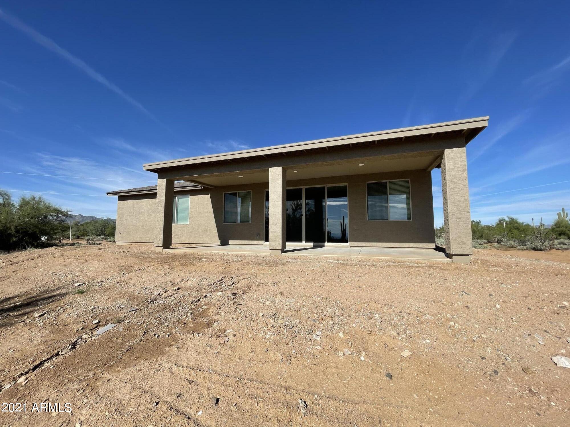 17009 East Bobwhite Way Rio Verde, AZ 85263 - Photo 11 of 12 a front view of a house with a yard and garage