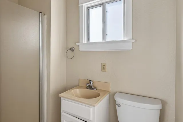 a bathroom with a toilet sink and mirror
