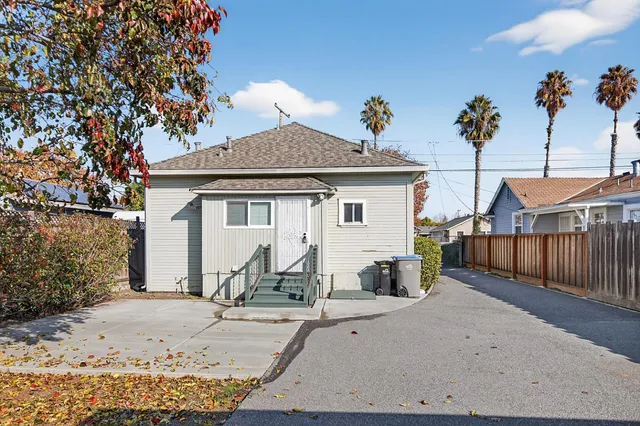 a view of a house with wooden fence