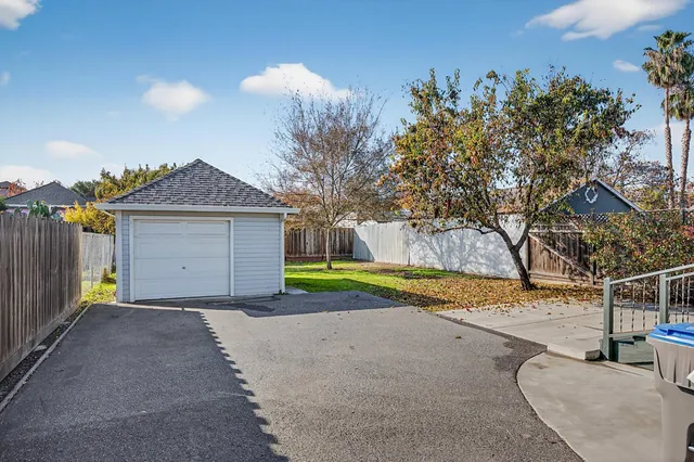 a view of a house with a yard and garage