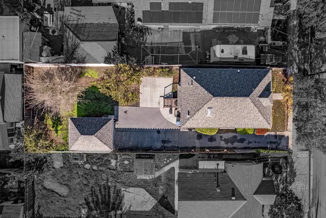 a aerial view of a house with large trees