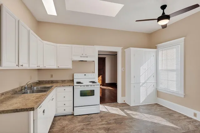 a kitchen with stainless steel appliances granite countertop a refrigerator sink and stove