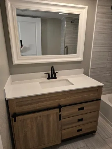 a bathroom with a sink and a mirror