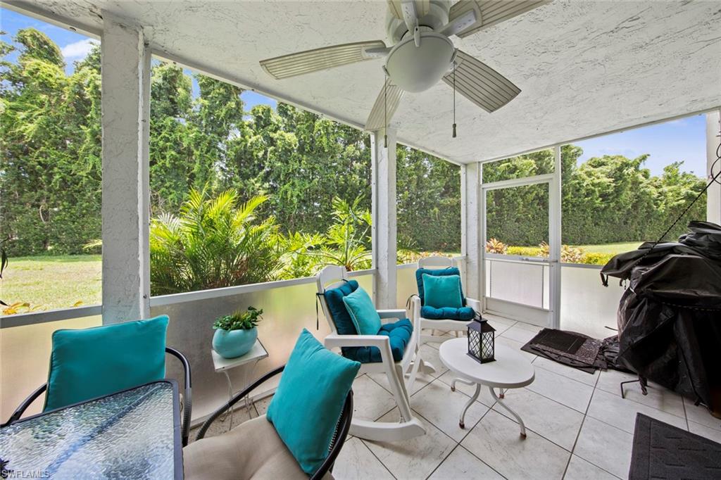 740 Teryl Road, Unit 1 Naples, FL 34112 - Photo 13 of 21 a living room with patio furniture and a floor to ceiling window