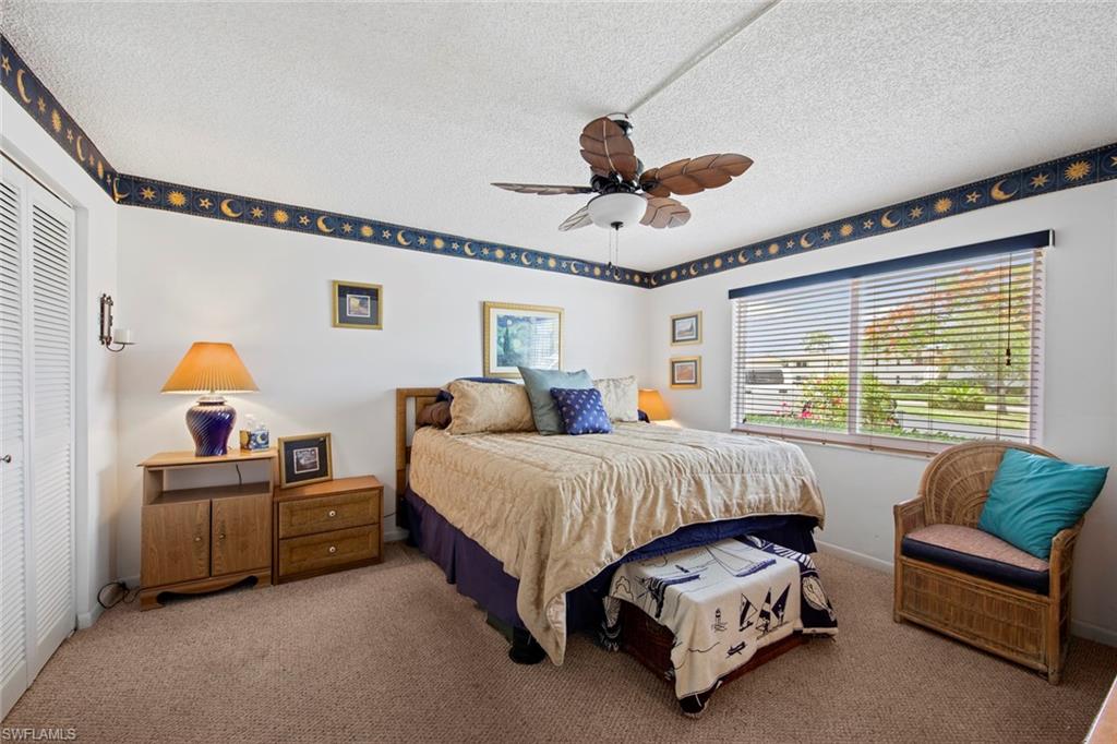 740 Teryl Road, Unit 1 Naples, FL 34112 - Photo 15 of 21 a spacious bedroom with a bed couch and window
