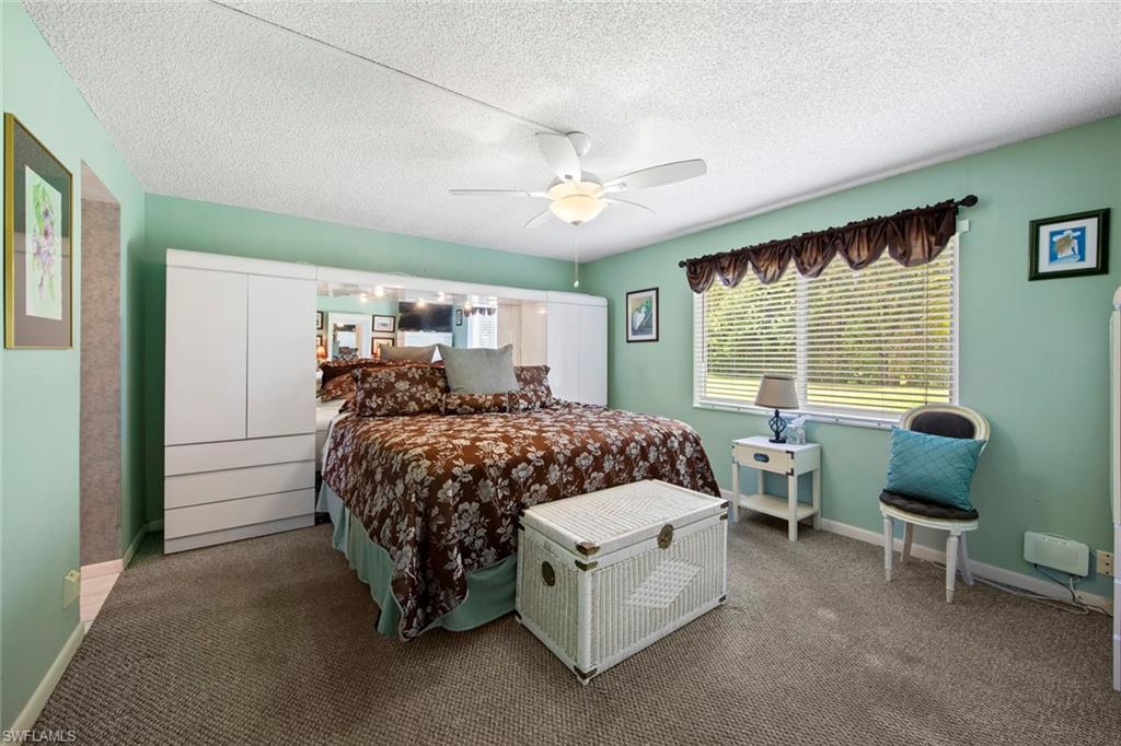 740 Teryl Road, Unit 1 Naples, FL 34112 - Photo 18 of 21 a bed room with a bed window and a chair