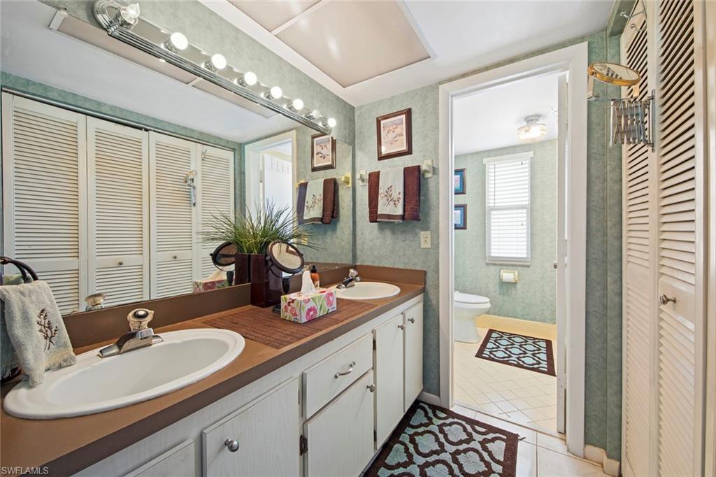 740 Teryl Road, Unit 1 Naples, FL 34112 - Photo 20 of 21 a spacious bathroom with a sink double vanity and a mirror