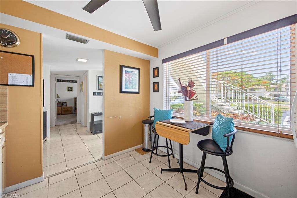 740 Teryl Road, Unit 1 Naples, FL 34112 - Photo 3 of 21 a dining room with furniture and a floor to ceiling window