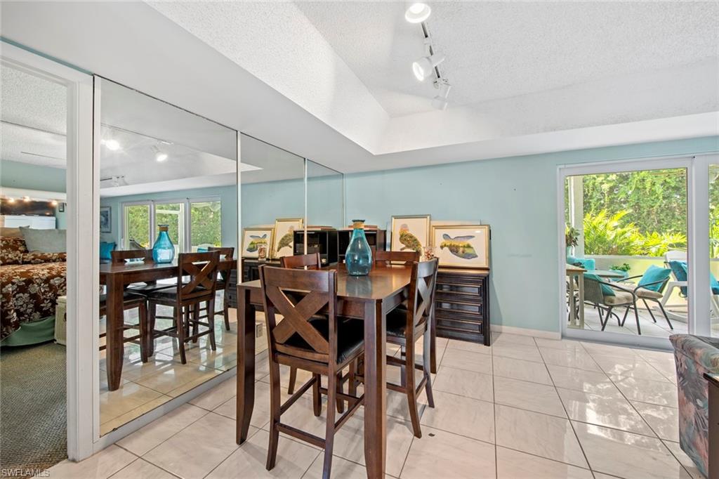 740 Teryl Road, Unit 1 Naples, FL 34112 - Photo 6 of 21 a view of a dining room with furniture window and outside view