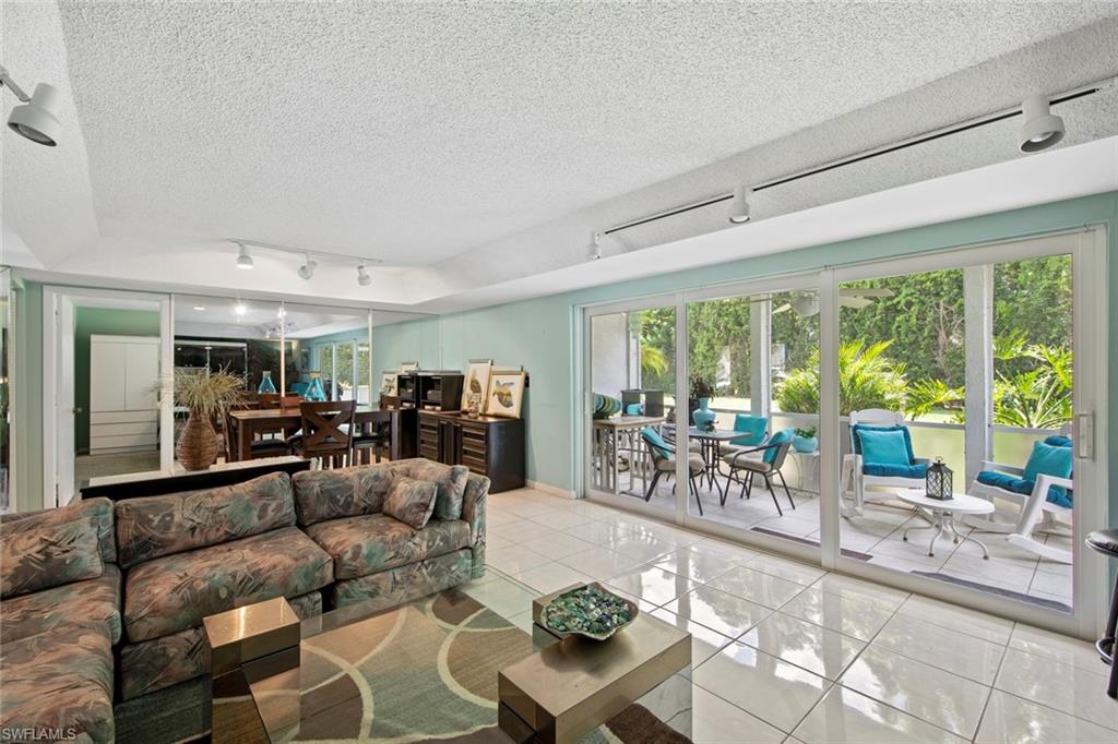 740 Teryl Road, Unit 1 Naples, FL 34112 - Photo 10 of 21 a living room with furniture and large windows