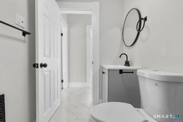 a bathroom with a toilet sink and shower