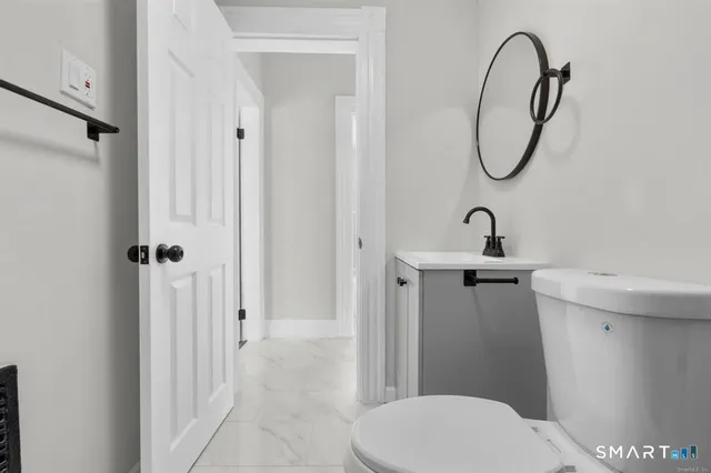 a bathroom with a toilet sink and shower