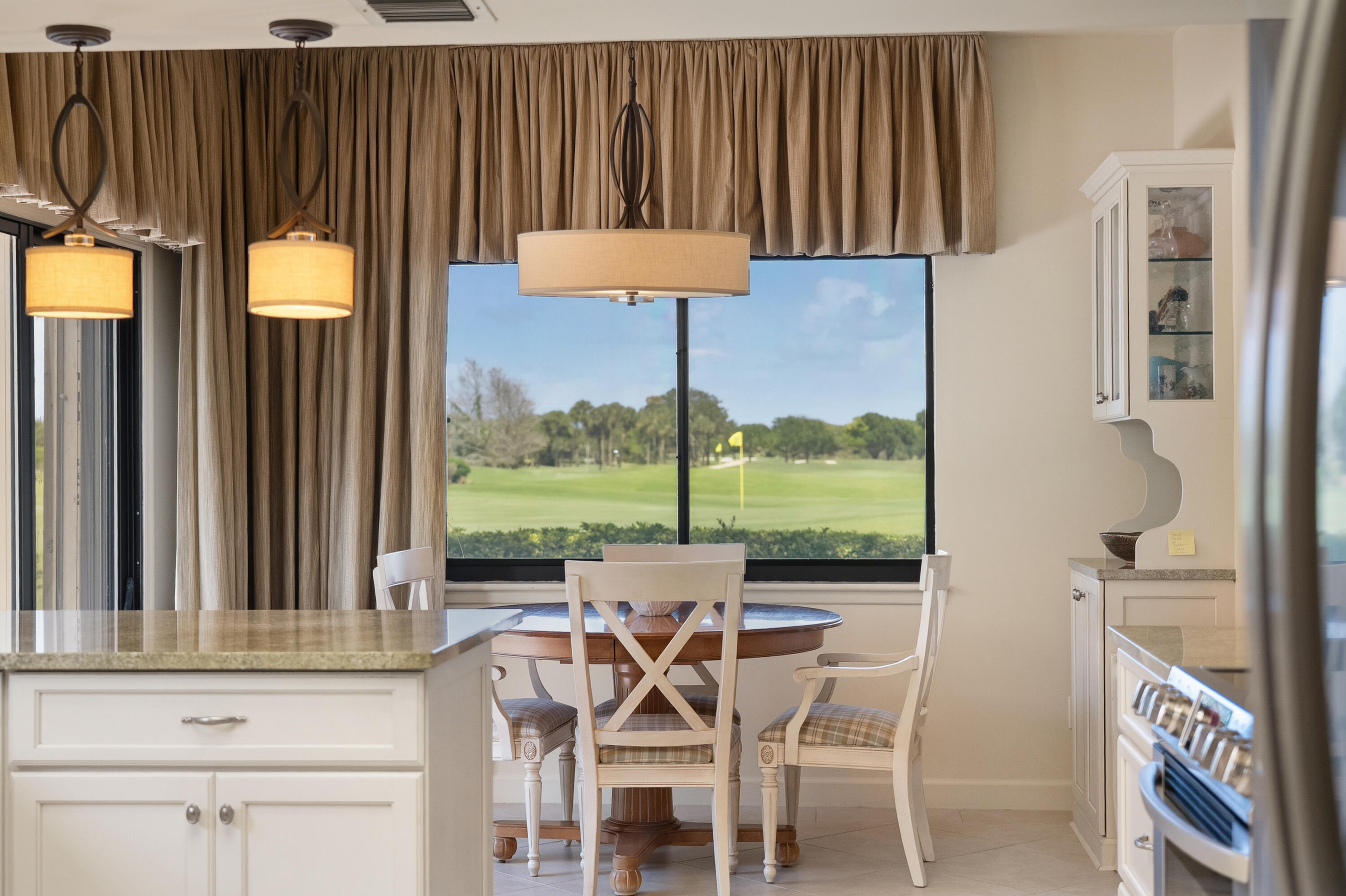 6997 Southeast Pacific Drive Stuart, FL 34997 - Photo 14 of 57 a dining room with furniture and a floor to ceiling window