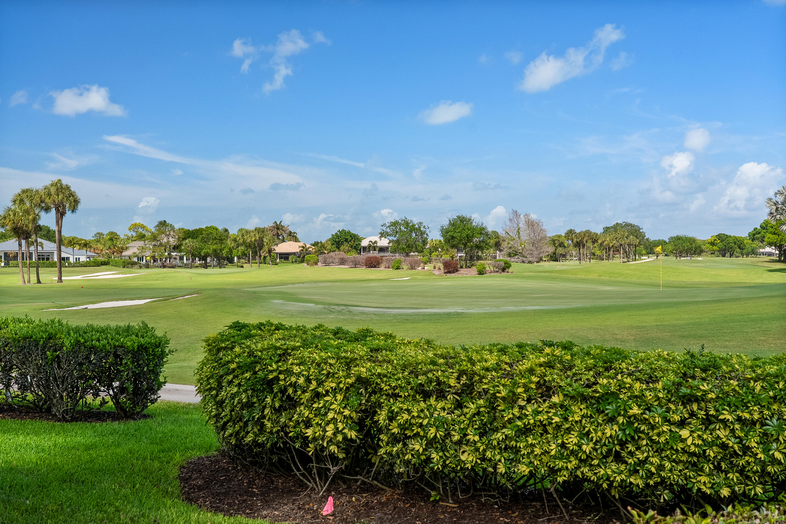 6997 Southeast Pacific Drive Stuart, FL 34997 - Photo 34 of 57 a view of a golf course with a lake