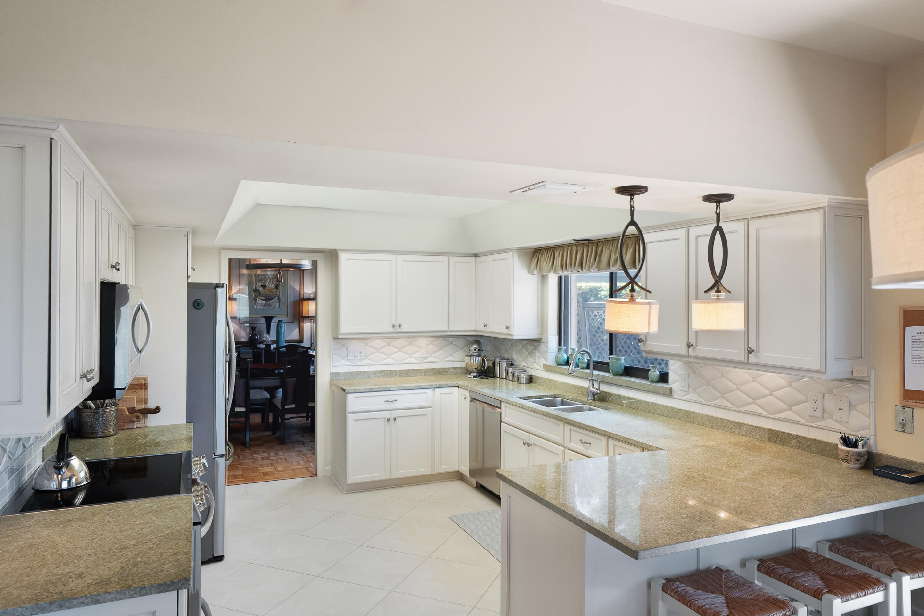 6997 Southeast Pacific Drive Stuart, FL 34997 - Photo 10 of 57 a kitchen with a sink stove and cabinets