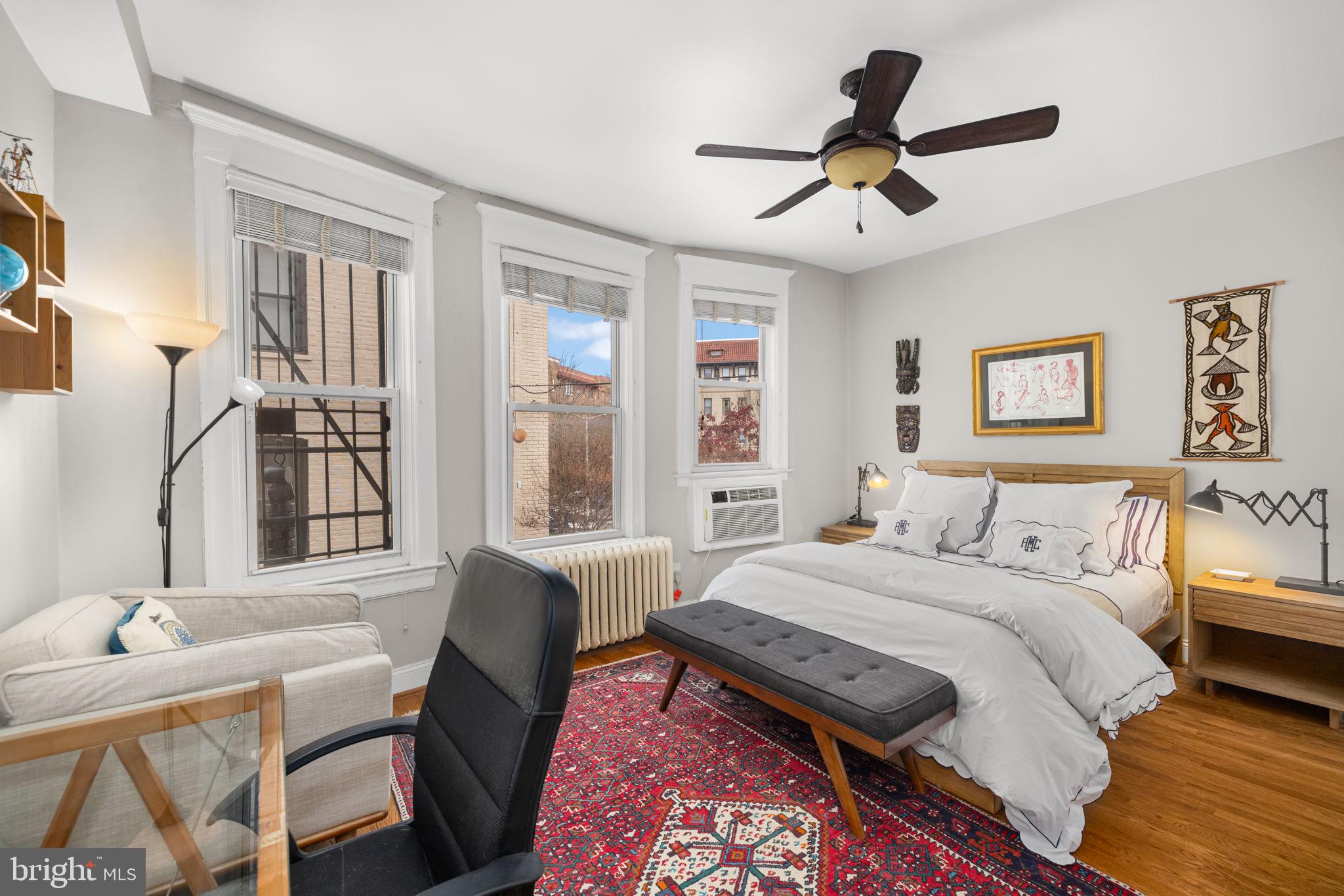 1855 Calvert Street Northwest, Unit 203 Washington, DC 20009 - Photo 6 of 9 a bed room with a bed and a chair