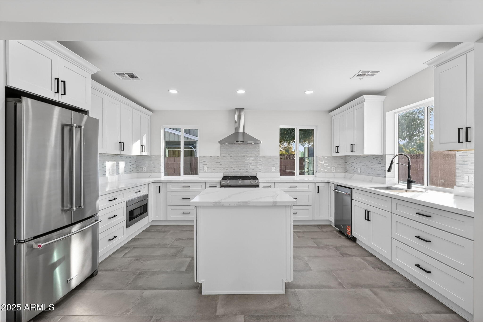 3241 North 27th Place Phoenix, AZ 85016 - Photo 3 of 25 a large kitchen with stainless steel appliances granite countertop a stove oven and a refrigerator