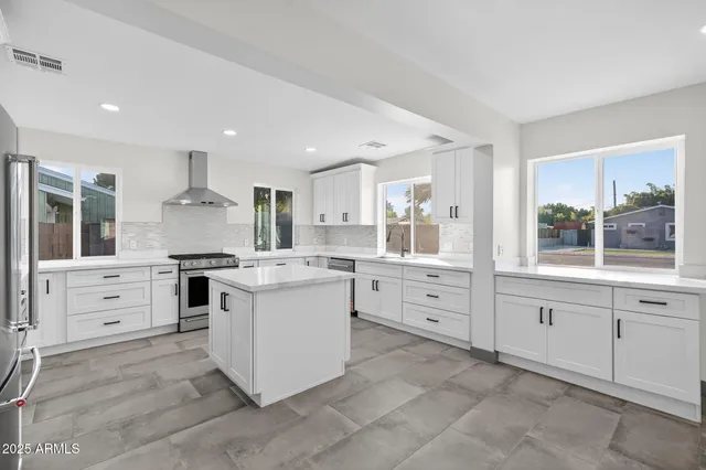 a kitchen with white cabinets and white appliances
